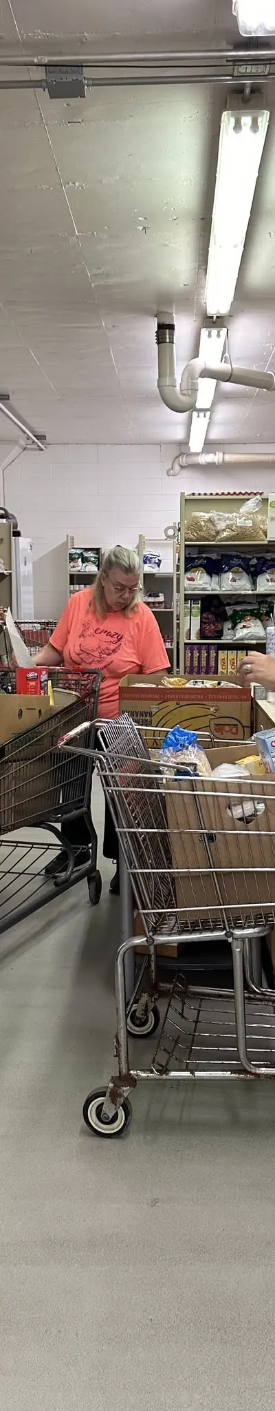 Volunteers filling carts from the shelves inside the Fort Atkinson Food Pantry